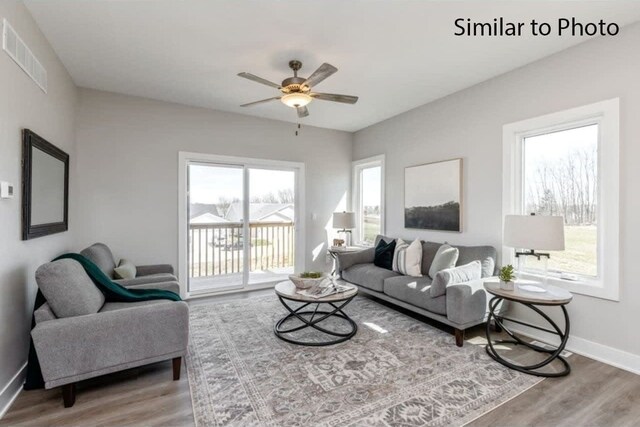 living room with ceiling fan, a healthy amount of sunlight, and hardwood / wood-style floors