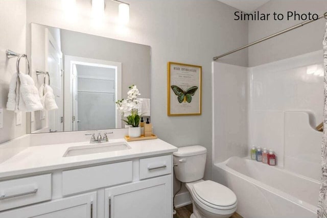 full bathroom featuring tub / shower combination, vanity, and toilet