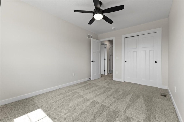 1991 S Warrior Ln, Waukee, IA 50263 - unfurnished bedroom with carpet floors, baseboards, a closet, and a ceiling fan