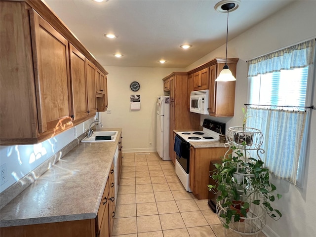 kitchen featuring sink, white appliances, decorative light fixtures, and light tile patterned floors