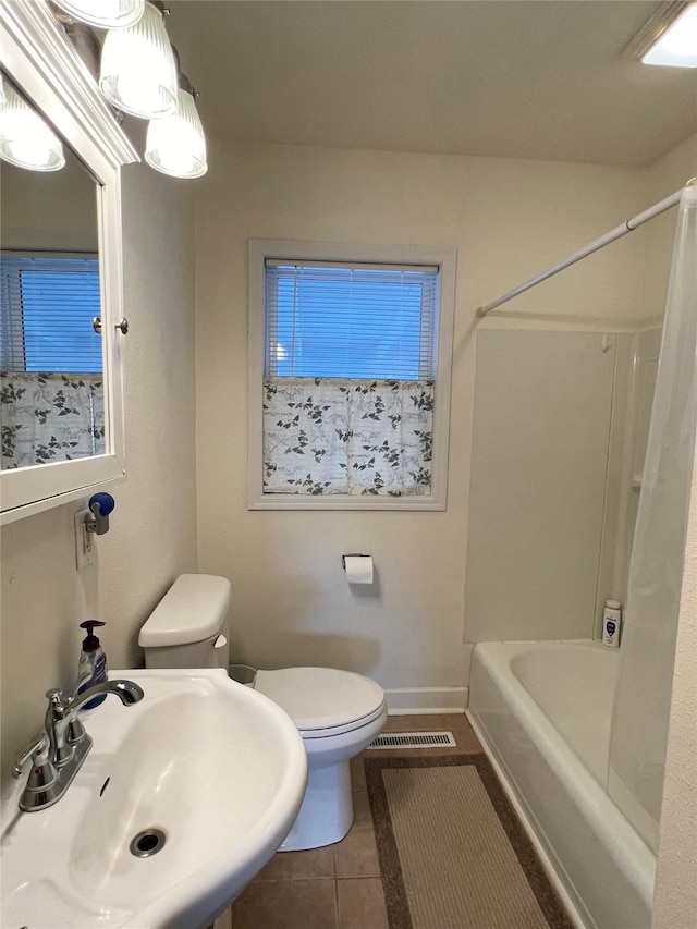 full bathroom featuring toilet, tile patterned flooring, shower / washtub combination, and sink