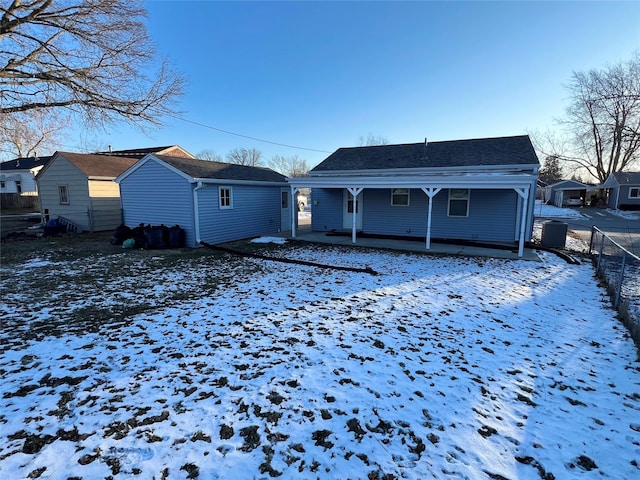 snow covered property featuring a porch and central air condition unit