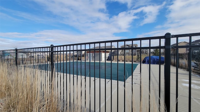 pool featuring a residential view and fence