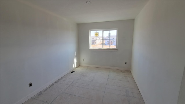 empty room featuring baseboards