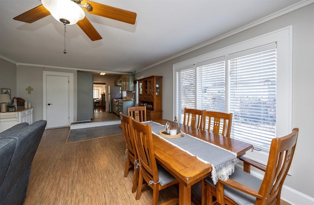 dining room featuring ceiling fan, ornamental molding, and light hardwood / wood-style flooring