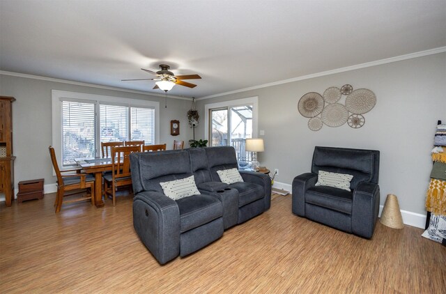 living room featuring ornamental molding, ceiling fan, and plenty of natural light