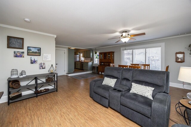 living room with ceiling fan, ornamental molding, and hardwood / wood-style flooring