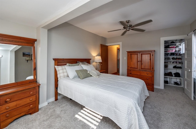 carpeted bedroom with ceiling fan and a closet