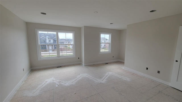 spare room with baseboards