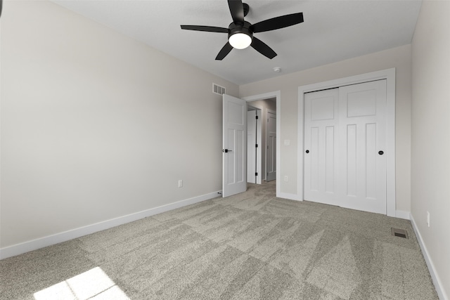 1994 S Warrior Ln, Waukee, IA 50263 - unfurnished bedroom featuring light carpet, baseboards, a closet, and a ceiling fan