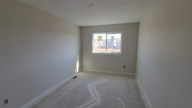 empty room featuring baseboards