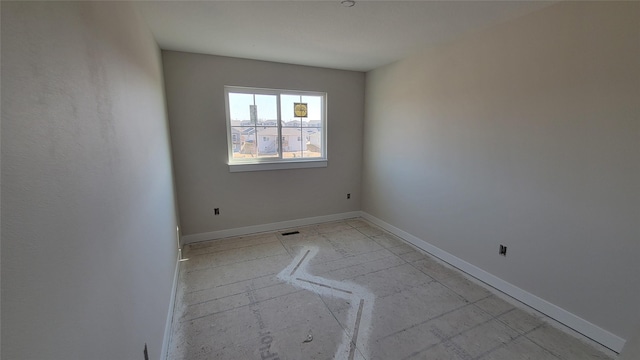 empty room with visible vents and baseboards