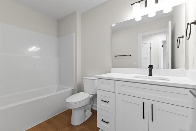 1995 S Warrior Ln, Waukee, IA 50263 - bathroom with toilet, vanity, wood finished floors, and bathtub / shower combination
