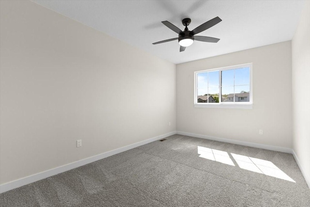 1995 S Warrior Ln, Waukee, IA 50263 - spare room featuring carpet flooring, ceiling fan, and baseboards