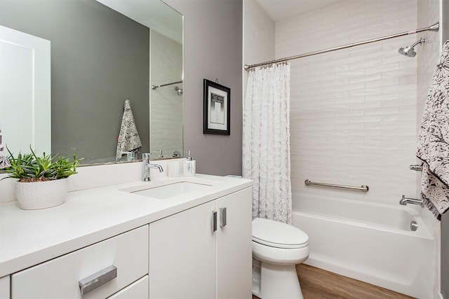 full bathroom with vanity, hardwood / wood-style floors, toilet, and shower / bath combo