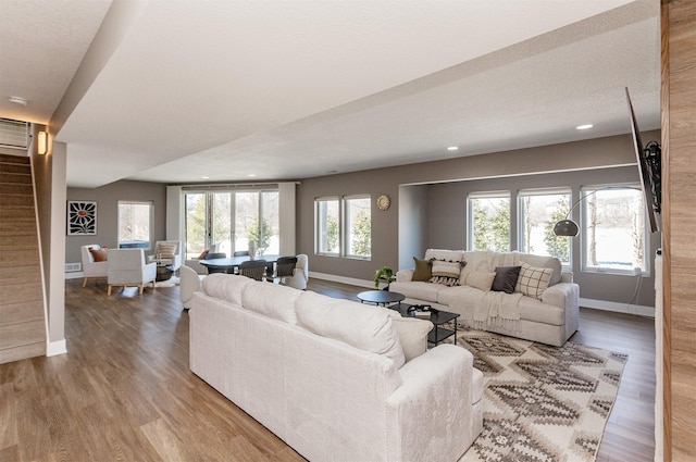 living room featuring a wealth of natural light and wood-type flooring