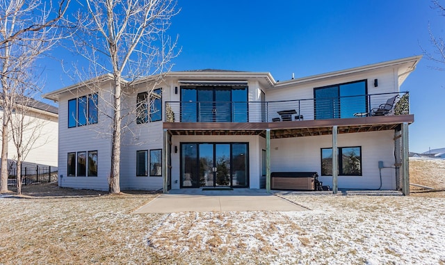 back of house featuring a patio area, a hot tub, and a balcony