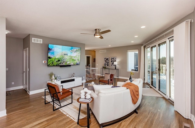 living room with hardwood / wood-style flooring and ceiling fan