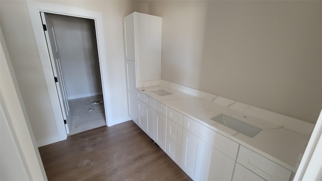 bathroom with baseboards and wood finished floors