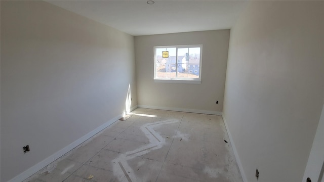 spare room with baseboards