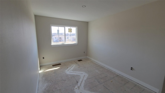 empty room featuring visible vents and baseboards