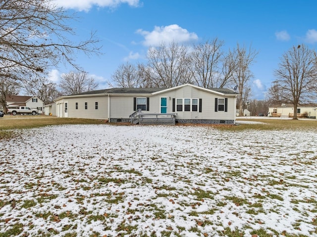 snow covered rear of property featuring a deck