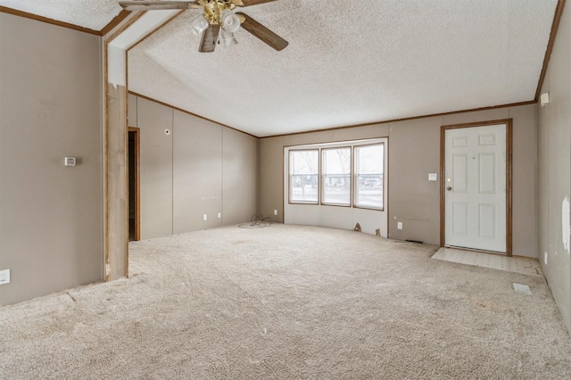 unfurnished living room with ceiling fan, crown molding, carpet floors, and a textured ceiling