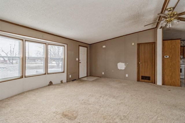 unfurnished living room with carpet flooring, a textured ceiling, and ceiling fan