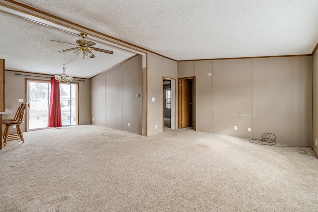 carpeted spare room featuring ceiling fan with notable chandelier, ornamental molding, a textured ceiling, and vaulted ceiling