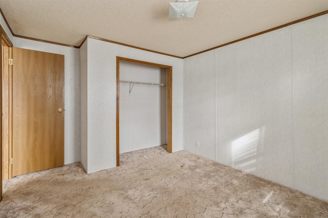 unfurnished bedroom with light colored carpet, a closet, and a textured ceiling