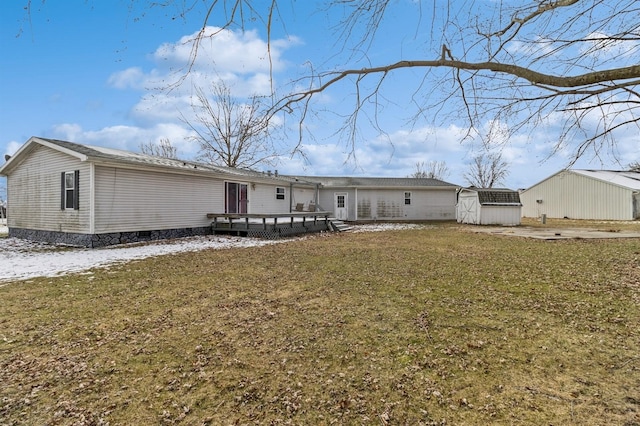 view of front of house featuring a front lawn, a shed, and a wooden deck