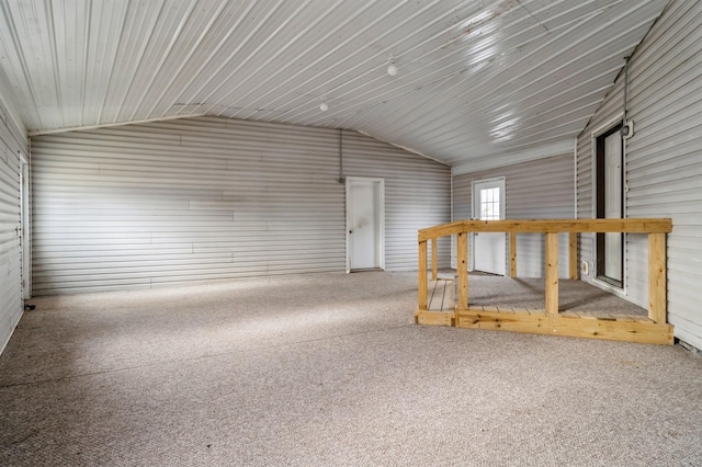 bonus room featuring wood walls and vaulted ceiling