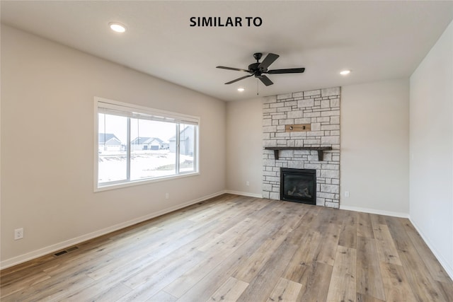 unfurnished living room featuring ceiling fan, light hardwood / wood-style flooring, and a fireplace