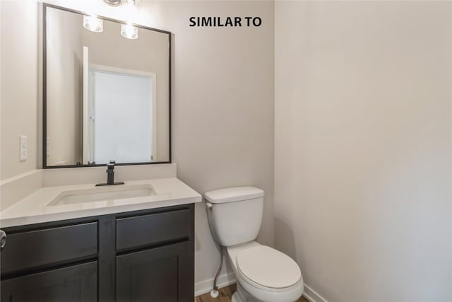 bathroom with toilet and vanity