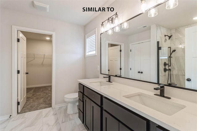 bathroom with toilet, vanity, and a shower