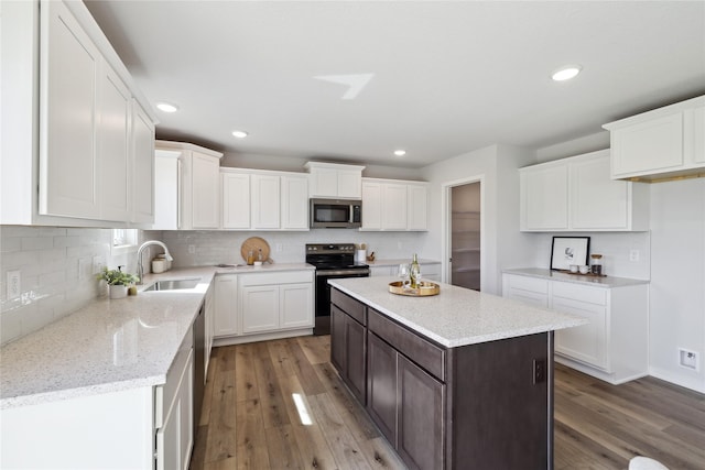 546 34th St SE, Altoona, IA 50009 - kitchen with stainless steel appliances, light wood-style flooring, white cabinetry, and recessed lighting