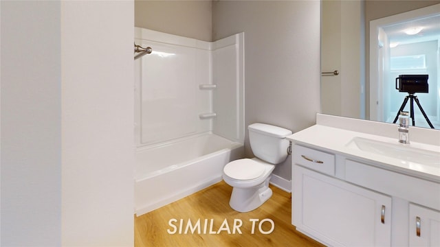 full bathroom with toilet, vanity, bathtub / shower combination, and hardwood / wood-style floors