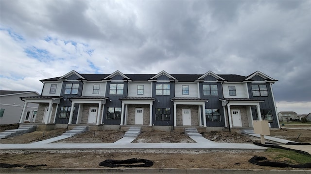 2024 S Warrior Ln, Waukee, IA 50263 - townhome / multi-family property with a standing seam roof, board and batten siding, metal roof, and stone siding