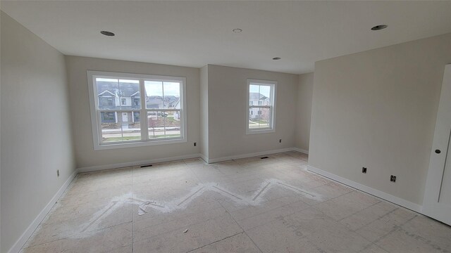spare room with baseboards