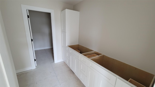 bathroom with tile patterned floors and baseboards