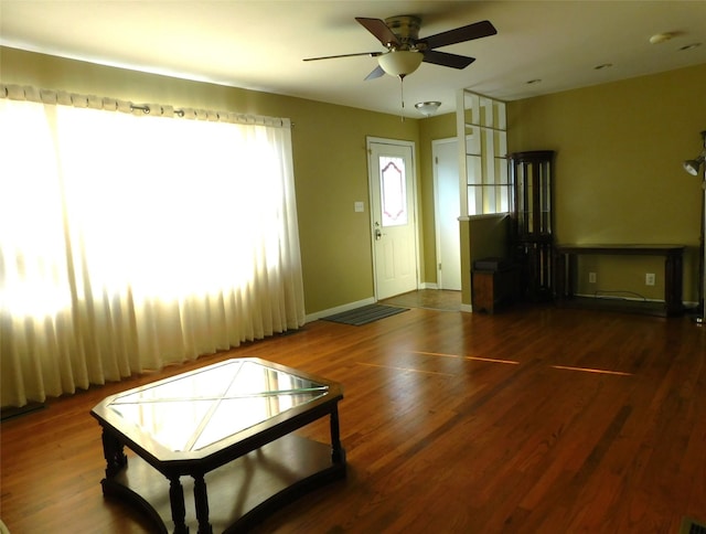 interior space with ceiling fan and dark wood-type flooring