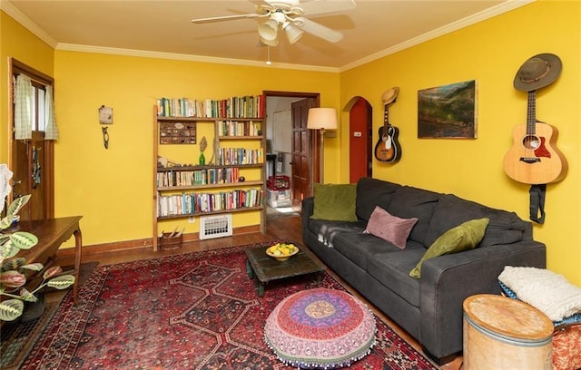 living room featuring ceiling fan and ornamental molding