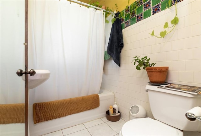 bathroom featuring tile patterned flooring, shower / tub combo, tile walls, and toilet