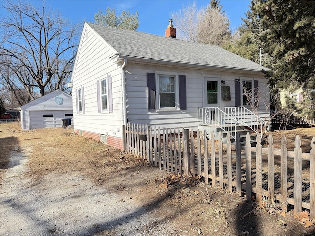 view of front of house featuring a garage and an outdoor structure