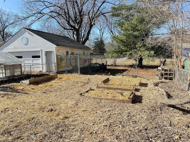 view of yard featuring a garage and an outbuilding