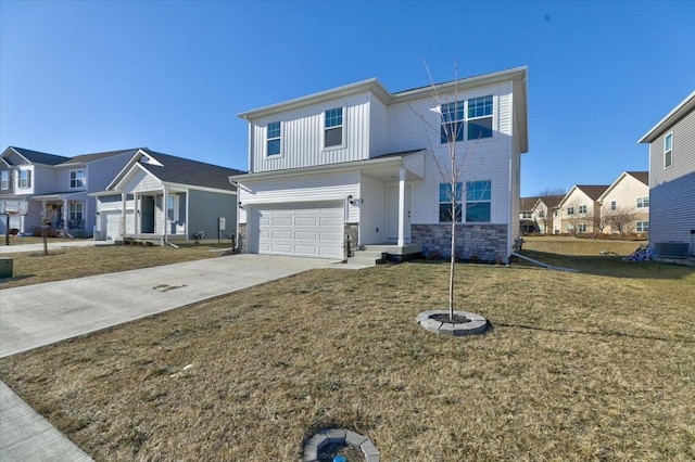 view of front of property with a front yard, a garage, and central AC unit