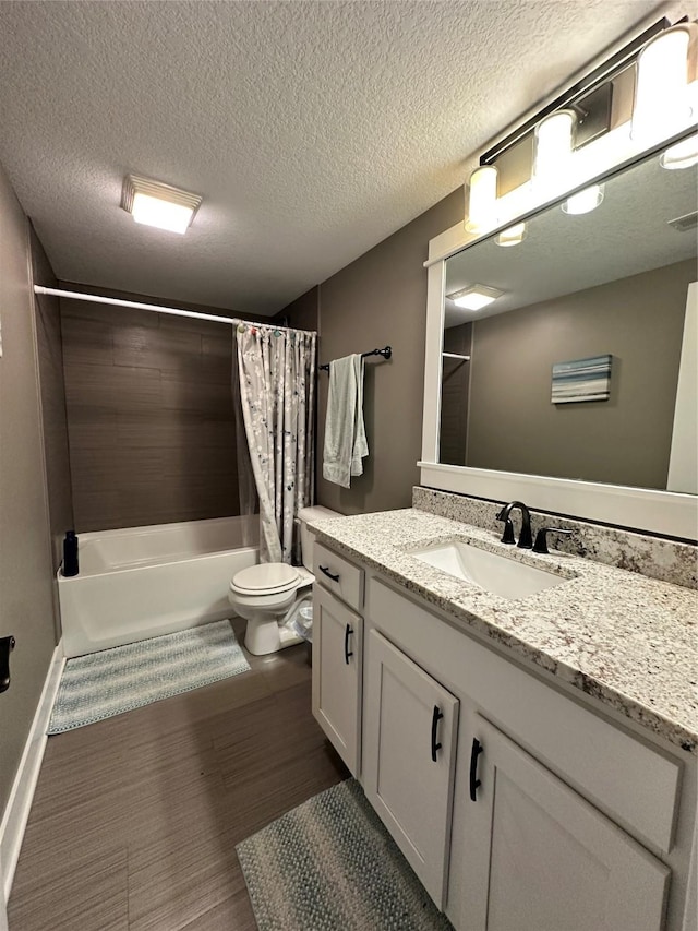 full bathroom featuring toilet, shower / bath combo with shower curtain, wood-type flooring, a textured ceiling, and vanity