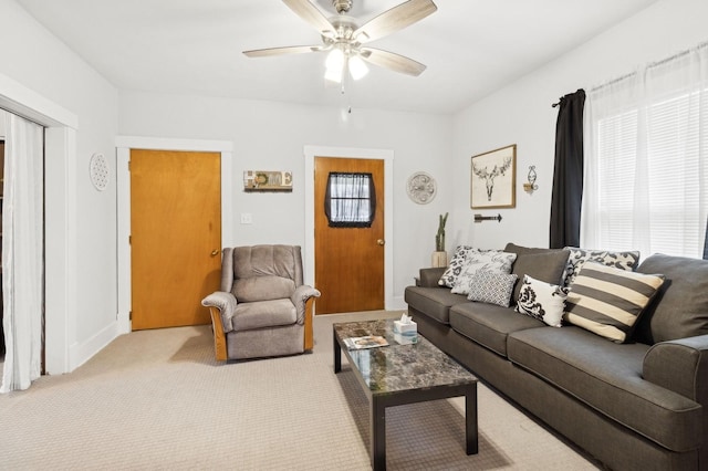 carpeted living room with ceiling fan