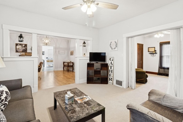 carpeted living room featuring ceiling fan