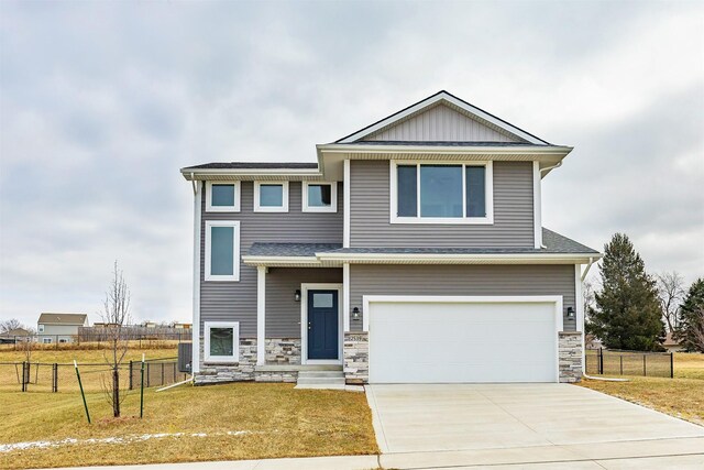 view of front of property featuring a front lawn and a garage